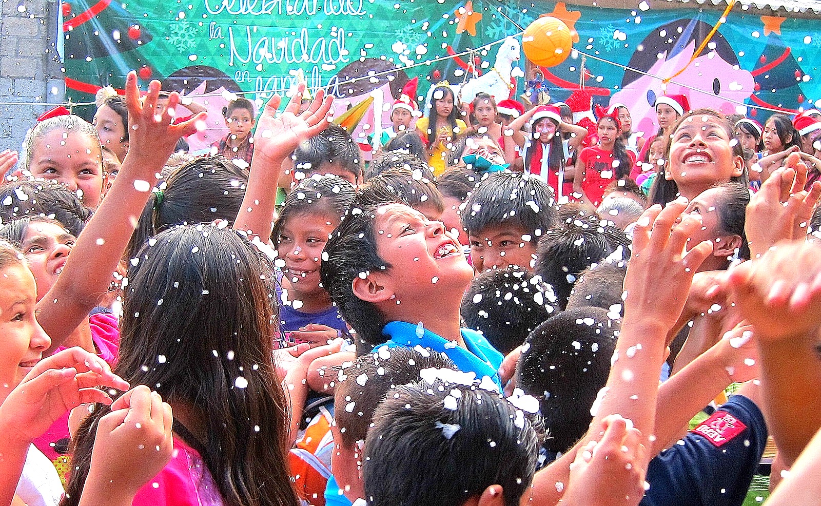 Children enjoying snow during the fiesta's Frozen show